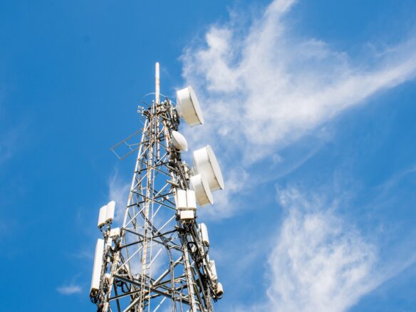 Radio, communication and cell tower on blue sky background